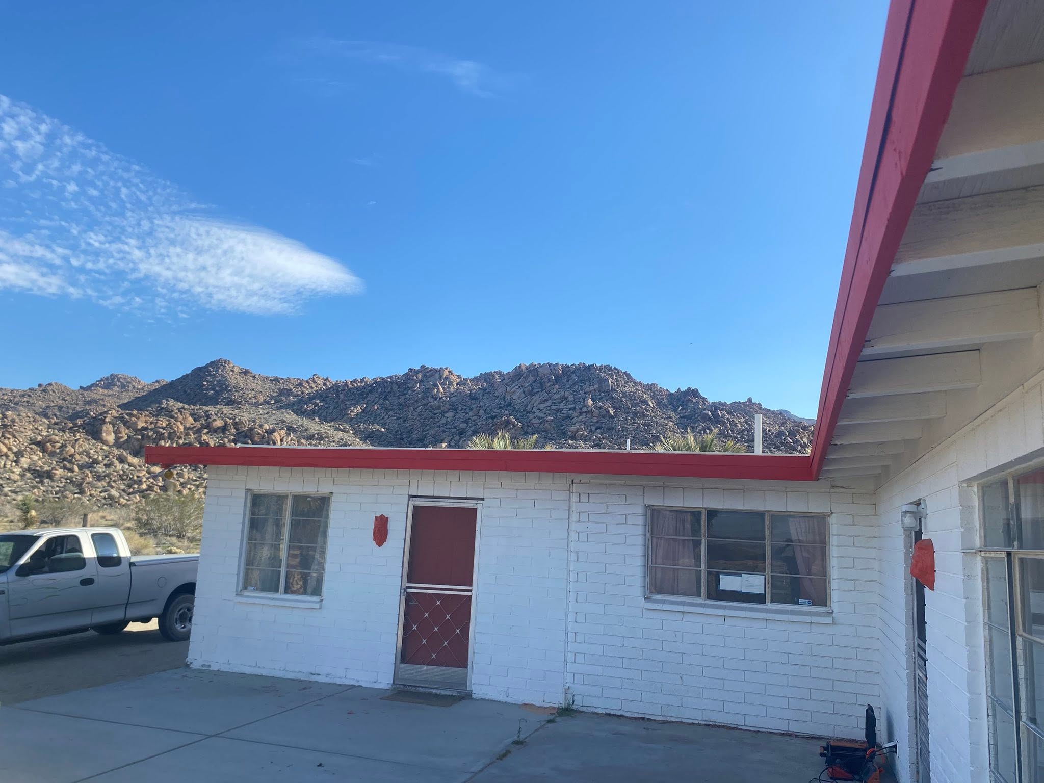 Exterior trim and paint preparation on white block building